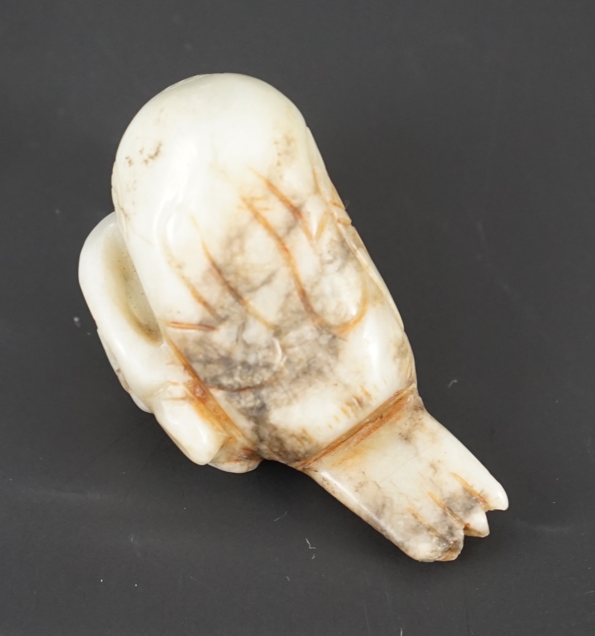 A Chinese white and black jade figure of a preening duck, Ming dynasty, 5.8 cm long